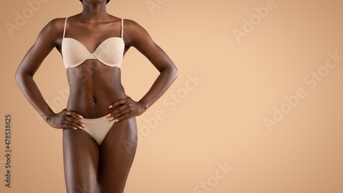 Black woman in underwear demonstrating her perfect body