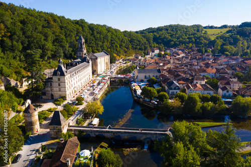 Scenic drone view of Brantome en Perigord on Dronne river with former Benedictine abbey on sunny summer day, Dordogne, France..