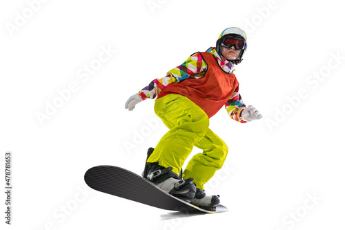 Portrait of young woman in bright sportswear, goggles and helmet snowboarding isolated on white studio background. Concept of winter sports