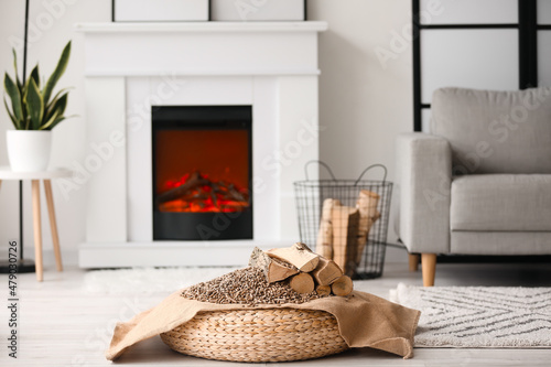 Firewood with pellets on pouf in living room