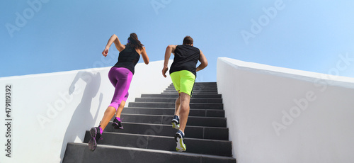 Stairs exercise couple athletes runners running up staircase training hiit interval training workout. Fitness gym active sport people climbing in urban city panoramic banner.