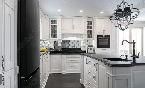 Beautiful, white, wooden kitchen with large island