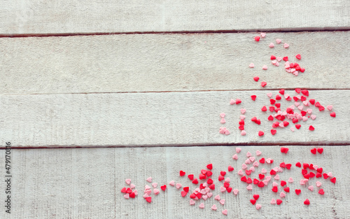 Valentines day background, many small hearts on white wooden table