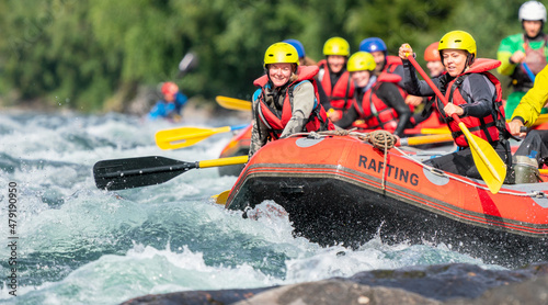 Two girls enjoying themself with river rafting water sports. Smiles, recreation and happiness concept. Removed logos.