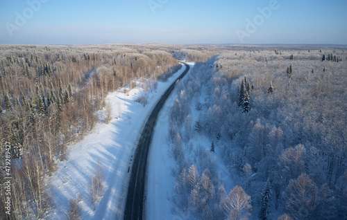 Aerial photo view of winter road in taiga on Salair Ridge in winter. Siberia, Russia