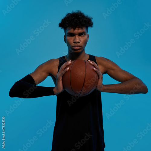 Young black male player hold basketball ball