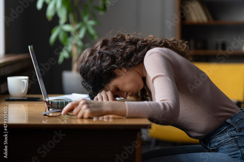 Work burnout. Tired exhausted female employee feeling energy depletion or exhaustion, overworked stressed female putting head down on table, suffering from chronic job stress. Overwork concept