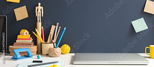 Homeschooling. Vintage workspace and variety of school supplies and laptop. Creative, artistic home office. Mockup.