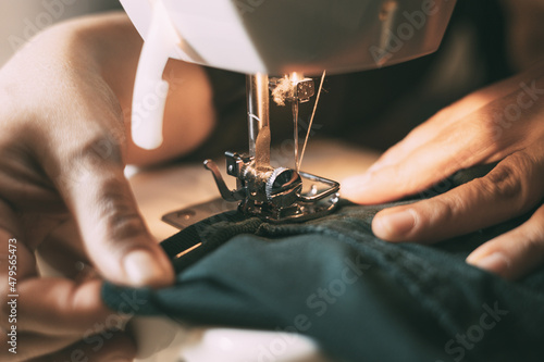 Hands working on the sewing machine