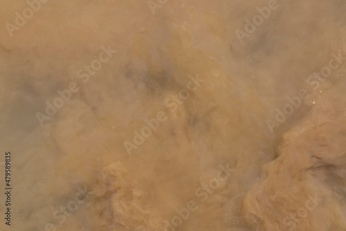 Cloudy, dirty water. Abstract brown background, pattern. Water surface.