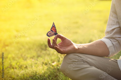 Man meditating outdoors on sunny day, closeup. Space for text