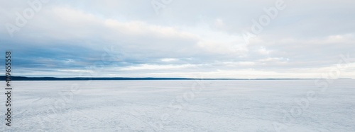 Frozen forest lake on a cloudy day. Dramatic sky after a blizzard. Onega, Karelia, Russia.Atmospheric winter landscape. Panoramic view. Nature, climate change, christmas vacations, eco tourism