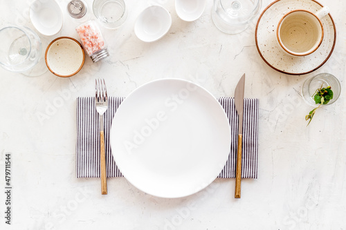 Crockery set - table setting for dinner with dishes and glasses