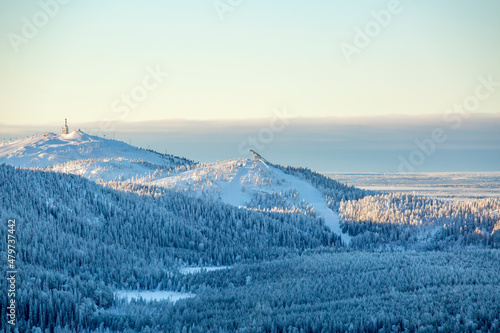 View of Ruka ski resort and the ski jumping hill during winter seen from Valtavaara hill, Finland, Europe