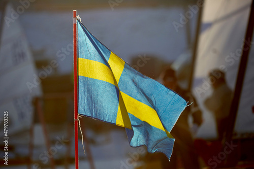 waving swedish flag on ice sailing