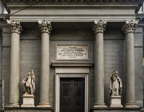 Façade of the Basilica Mauriziana in neoclassical style with a large triangular pediment and two imposing statues representing Saints Maurice and Lazarus (1834), Turin, Piedmont, Italy