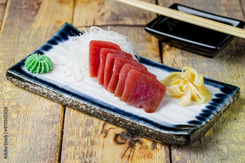 fresh sliced sashimi tuna on wooden table