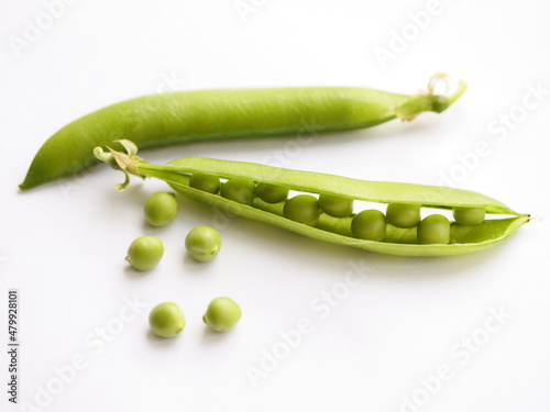 Peas in pod isolated on white background, on table. Fresh pea seeds. Close up. 