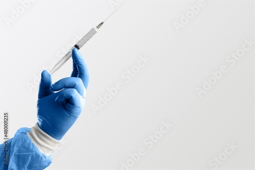 A doctor holds vaccine against new covid-19 omicron variant on a background