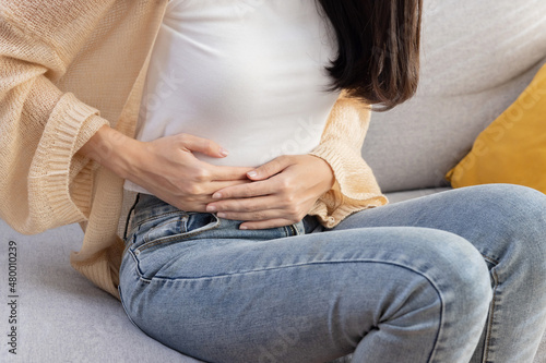 Woman Grab Her Stomach with Pain Suffer From Stomachache or Menstruation