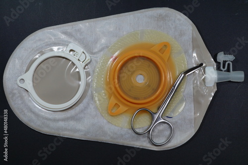 Urostomy and nephrostomy bag - Ostomy medical care equipmen: Two-piece urostomy bag with the valve adhered to the skin of the patient. Ostomy plate for fixing urostomy bag