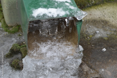 an icy gutter with a large amount of ice on it that interferes with the normal flow of water from the roof