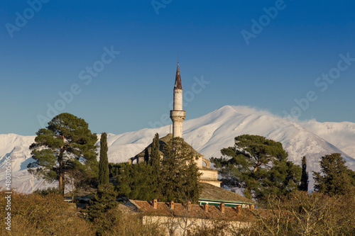 mosque in ioannina city greece snow in mountains in its kale area