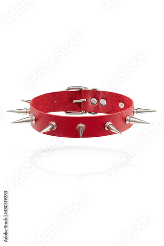 Detail shot of red leather collar with steel sharp thorns and metal buckle. Stylish adjustable choker is isolated on the white background. 