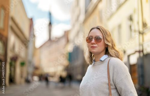 Female tourist in sunglasses in old Tallinn.
