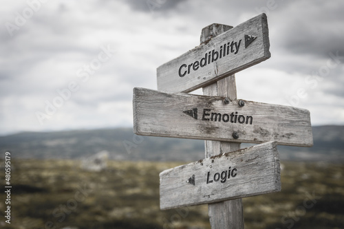 credibility emotion logic text on wooden sign outdoors.