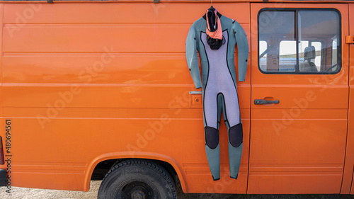 Neoprene wetsuit hanging in the caravan orange