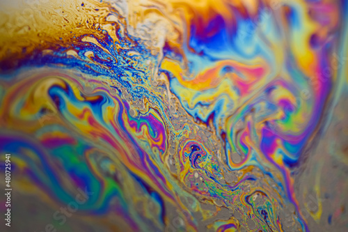 Vibrant colored multicolor psychedelic surface of soap bobble close-up