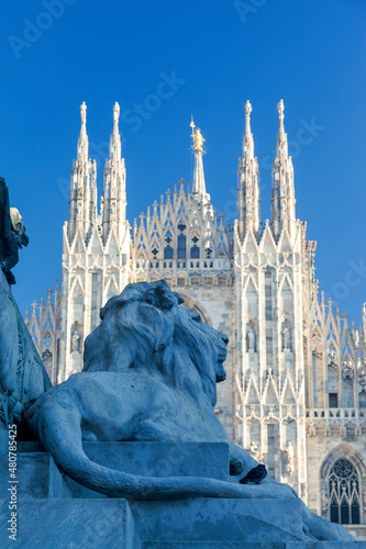 Piazza del Duomo, the most famous square in Milan, Italy. In foreground, the lion at the Vittorio Emmanuelle statue and at the back the impossive Duomo Cathedral, the landmark of Milan city.