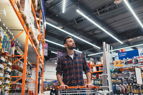 buy a man walking with a basket in a hardware store