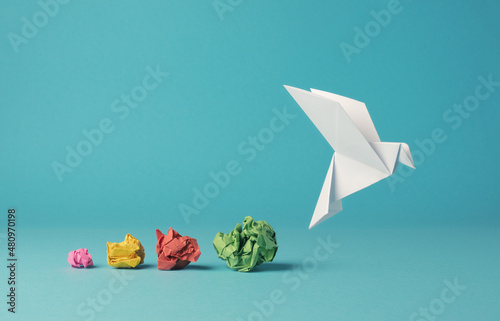 Colorful crumpled paper balls with a paper dove, peace, freedom or opportunities