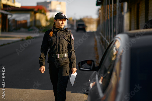 Female cop coming to car on road