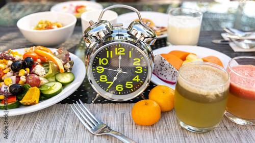 Selective focus of alarm clock which the concept of proper nutrition. Diet intermittent fasting image