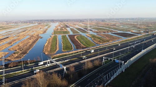 Highway photographed from the air with a drone. Along the Dutch city of Zaandam in the Netherlands with a polder landscape in the background. Choose destination and arrive at your goal.