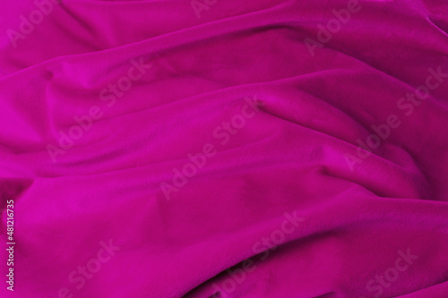 Texture pink fabric top view. Pink fuchsia soft pleated fabric