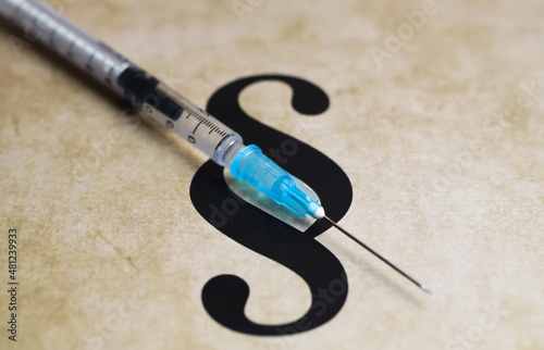 Closeup of paragraph symbol with vaccination injection syringe - euthanasia assisted suicide dying concept