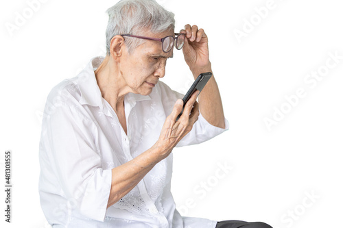 Asian senior woman with eye glasses,try to read messages,gaze at the small text on mobile phone,age related macular degeneration,blurred vision,poor eyesight problems,eye disease of the old elderly