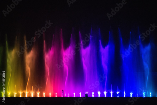  Beautiful fountain dancing show with reflection on water at night.