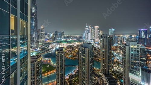 Dubai downtown with fountains and modern futuristic architecture aerial night timelapse