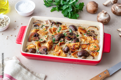 Baked chicken and mushrooms in a creamy sauce. French cuisine. Fricassee.