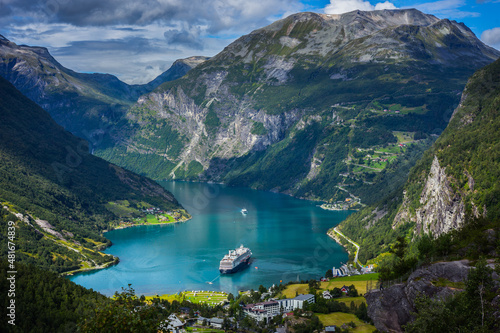 Cruise ships stand in the harbor of the Geiranger fjord, Norway