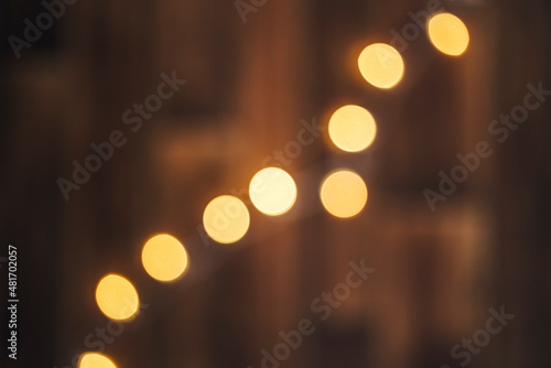 Out of focus wooden background with bokeh lights on it. Christmass abstract background.