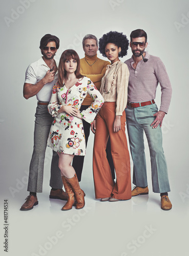 Nothing like some 70s style. A studio shot of a group of people standing together while clad in retro 70s wear.