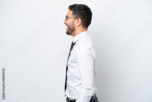 Business Brazilian man isolated on white background laughing in lateral position