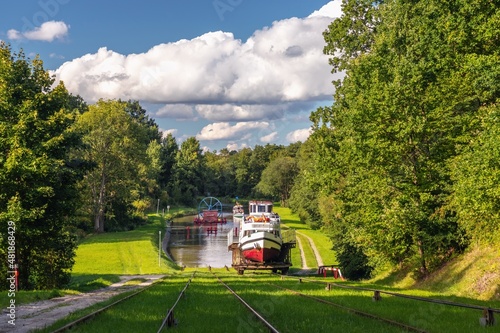 Green nature of the Elbląg Canal (Kanał Elbląski), famous landmark of Warmian-Masurian, Poland. Boat hauled on the link cradle up the inclined plane to overcome the difference in water levels.