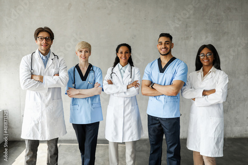 Multiracial medical team posing at clinic while having team-building